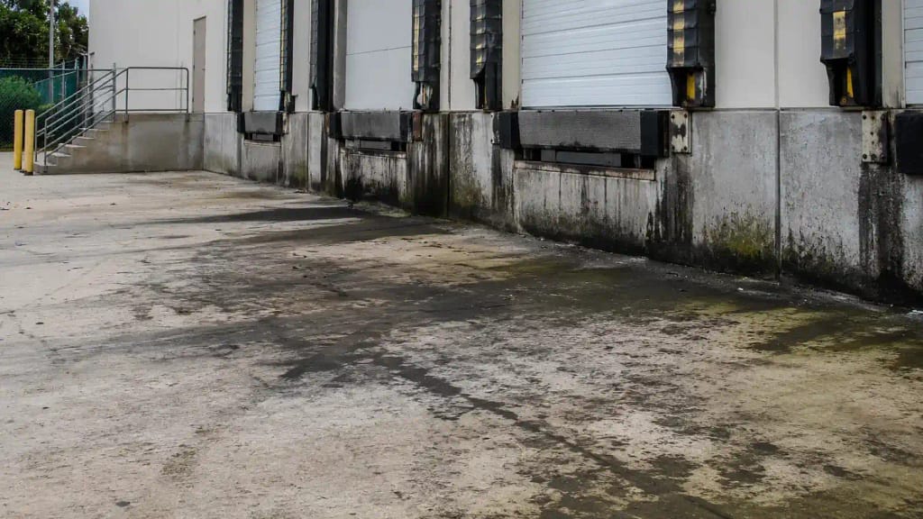 5 Signs Your Warehouse Needs Professional Cleaning in Miami, FL 3 Contaminated exterior loading dock concrete at Miami FL warehouse facility