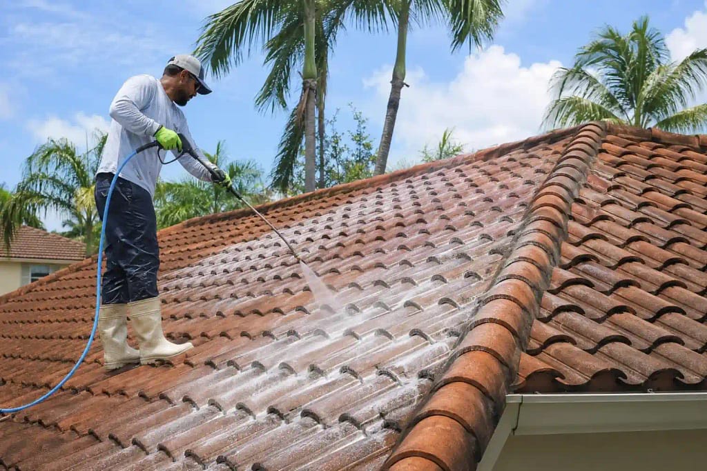 What Is Soft Washing and Why Miami Roofs Need It 3 Professional applying soft wash solution to a clay tile roof in Miami Florida