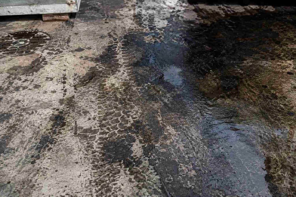 Commercial vs Residential Pressure Washing in Miami: What's the Difference? 3 Grease and oil stained concrete at a commercial property in Miami FL