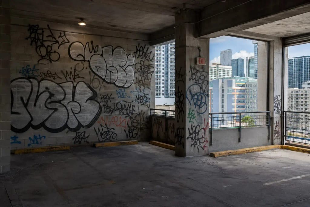 How Graffiti Affects Commercial Property Value in Miami 3 Graffiti tags on concrete walls inside a Miami FL commercial parking structure